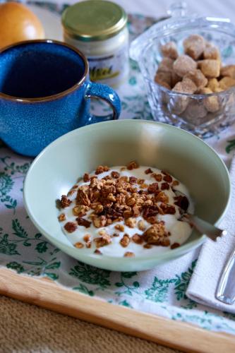 a bowl of cereal with nuts and a cup of coffee at Le Sommelier in Bailleul