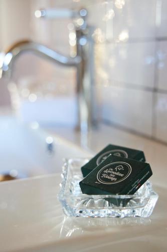 a bar of soap sitting on top of a sink at Le Sommelier in Bailleul