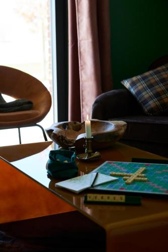 a table with a candle and a bowl on it at Le Sommelier in Bailleul