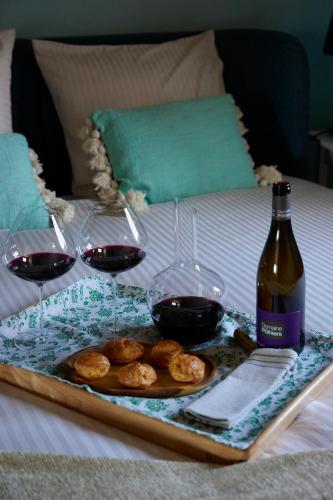 a tray with two glasses of wine and a plate of food at Le Sommelier in Bailleul