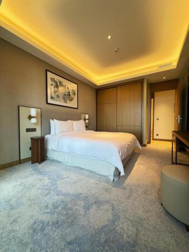 a large bedroom with a large white bed in it at The address opera t1 burj khalifa in Dubai