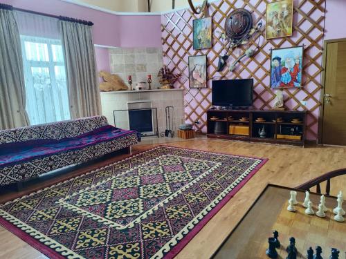 a living room with a couch and a rug at Tagaytay Karakol Hotel in Karakol