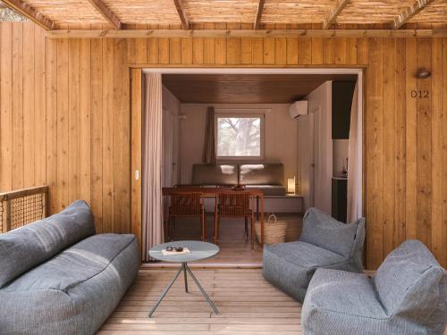 a living room with a couch and chairs and a table at wecamp Cala Montgó in L'Escala