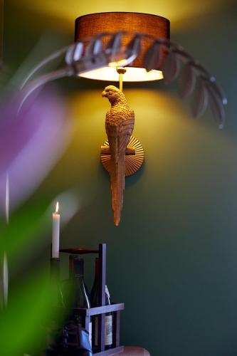 a bird on a lamp with a bird on it at Le Sommelier in Bailleul