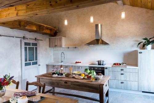 a kitchen with a table with fruits and vegetables on it at Maison de la Combe in Castelmoron-sur-Lot