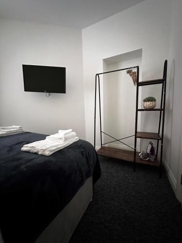 a bedroom with a bed and a flat screen tv at Apt 1, Soho Apartments 1st floor by Indigo Flats in London