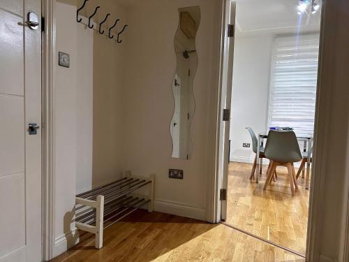 a room with a door with a dress hanging on the wall at Apt 1, Soho Apartments 1st floor by Indigo Flats in London
