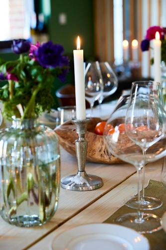 a table with a candle and wine glasses on it at Le Sommelier in Bailleul