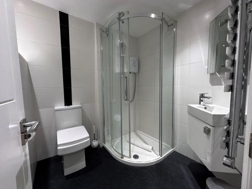 a bathroom with a shower and a toilet and a sink at Apt 3, Soho Apartments 2nd & 3rd floors by Indigo Flats in London