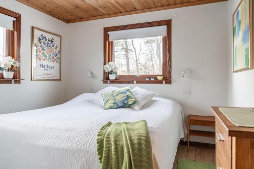a bedroom with a white bed and a window at Holiday home within walking distance to sandy beach in Båstad