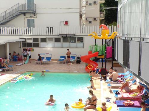 a group of people playing in a swimming pool at Hotel Faber in Rimini