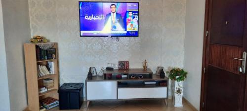 a living room with a tv on a wall at Residence salam in Agadir