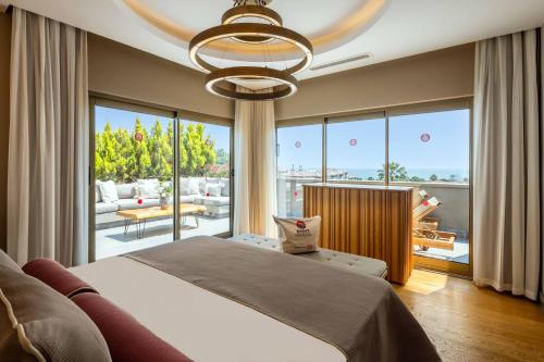 a bedroom with a large bed and a large window at Barut Hemera - Ultra All Inclusive in Side