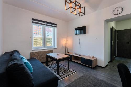 a living room with a couch and a table at Apartmány Praha-Modřany in Prague