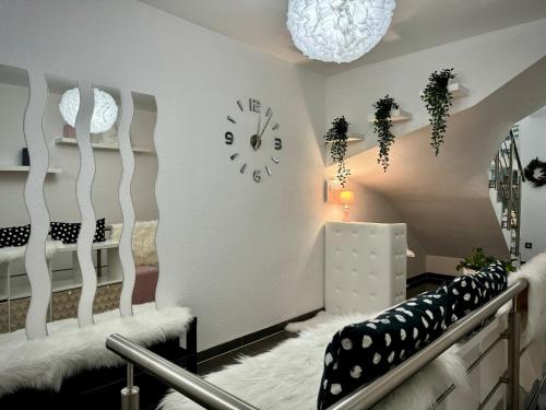 a white room with a clock on the wall at Vila GARUFA Wellness & Spa in Stará Lesná