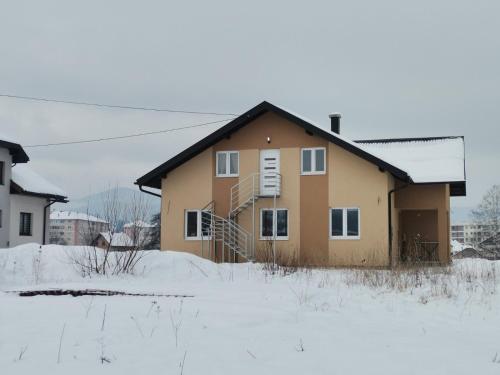 a house in the snow in a field at Stan na dan Luna in Pale