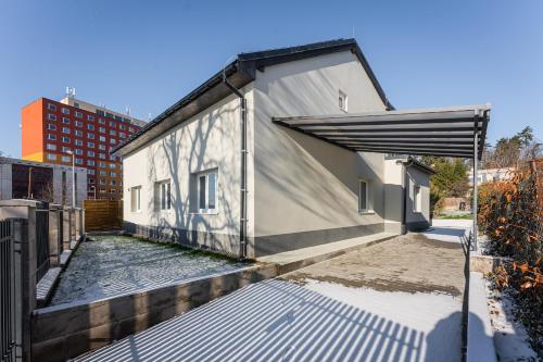 a building with an open door on the side of it at Apartmány Praha-Modřany in Prague