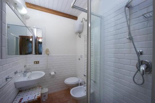 a bathroom with a sink and a toilet and a shower at Tenuta Decimo - Il Borgo Di Mariano in San Gimignano