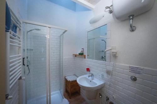 a white bathroom with a sink and a shower at Tenuta Decimo - Il Borgo Di Mariano in San Gimignano