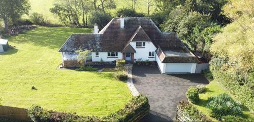 an aerial view of a white house with a yard at Broad Mead in Corfe Castle