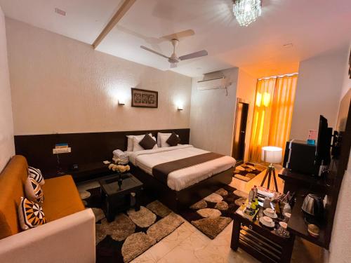 a bedroom with a bed and a living room at The कस्तूरी in Maihar