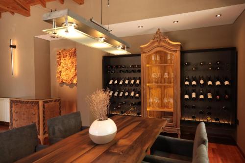 a dining room with a table and a wine cellar at Heura Petit Hotel in Ciudad Lujan de Cuyo