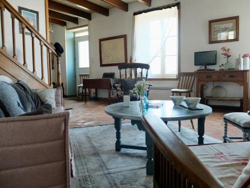 a living room with a table and a couch at Maison de pêcheur Loguivy de la mer pour 7pp in Ploubazlanec