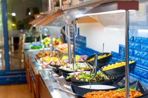 a buffet line with many plates of food at MPM Hotel Condor - All Inclusive Light in Sunny Beach