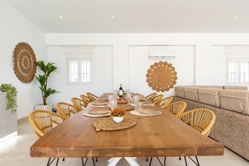 a dining room with a wooden table and chairs at MalagaSuite Villa Nomada El Torcal in Antequera