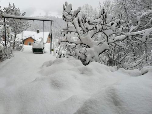 a garden covered in snow next to a bus stop at Naturparadies in Marktl