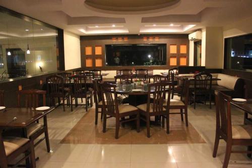 a dining room with tables and chairs in a restaurant at Shiva Oasis Resort in Neemrana