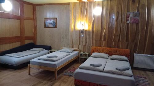 a living room with two beds and a couch at Atpūtas vieta Buki in Ventspils