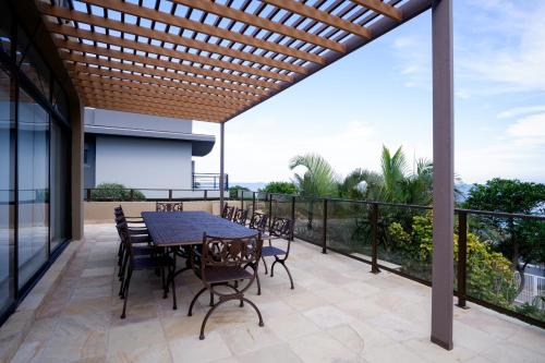 a patio with a table and chairs on a balcony at 145 Forest Drive - Umhlanga in Durban