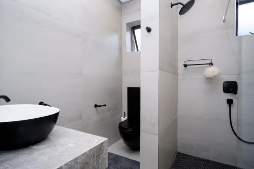 a bathroom with a tub and a sink and a toilet at 145 Forest Drive - Umhlanga in Durban