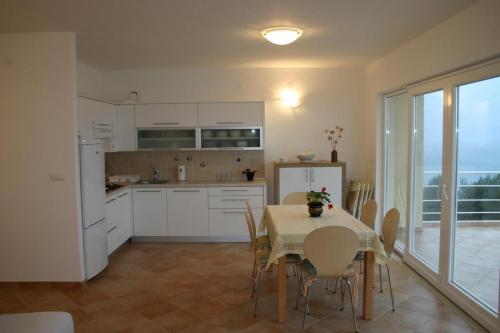 a kitchen and dining room with a table and chairs at Apartments Boris in Omiš