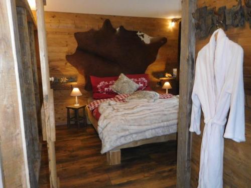 a bedroom with a bed in a wooden cabin at Wellnessoase mit Sauna und Whirlpool in Inzell