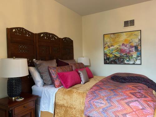 a bedroom with a bed and a painting on the wall at Norfolk Guest House Inn in Guelph