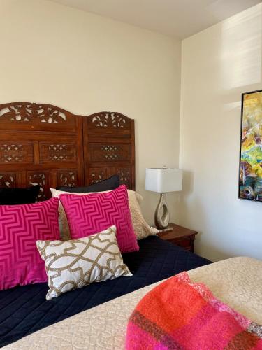 a bedroom with a bed with pink and purple pillows at Norfolk Guest House Inn in Guelph