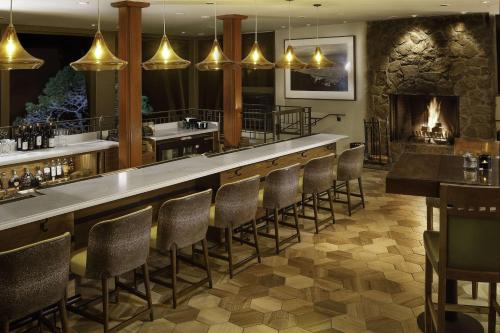 a bar with chairs and a fireplace in a restaurant at Hyatt Vacation Club At Highlands Inn in Carmel