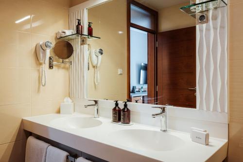 a bathroom with a sink and a mirror at Hotel Slatina Superior in Rogaška Slatina