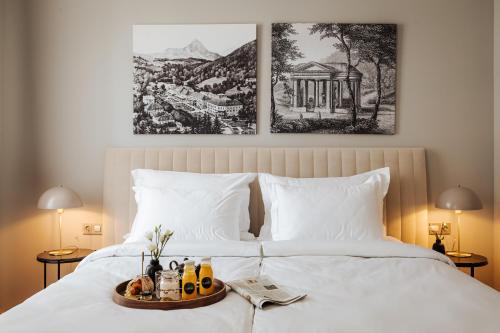 a bed with a tray of food on it at Hotel Slatina in Rogaška Slatina