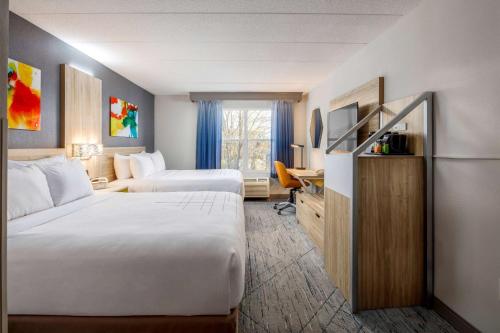 a hotel room with two beds and a desk at La Quinta by Wyndham Lexington Park - Patuxent in California