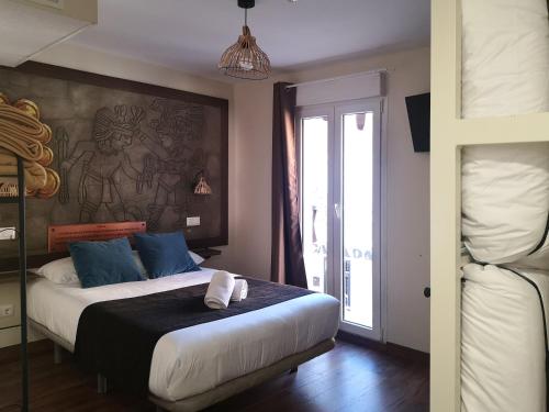 a bedroom with a bed with a painting on the wall at El Indio Chocolatería Boutique in Pinto