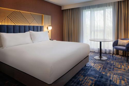 a large white bed in a hotel room at DoubleTree by Hilton Coventry in Coventry