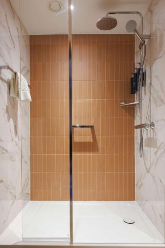 a shower with a glass door in a bathroom at DoubleTree by Hilton Coventry in Coventry