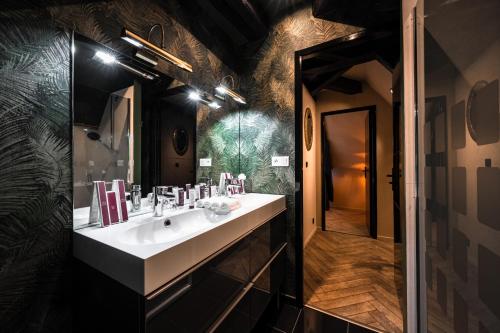 a bathroom with a white sink and a mirror at Château de Maubreuil in Carquefou