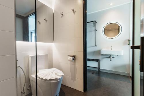 a bathroom with a toilet and a sink at POR Arak in Chiang Mai