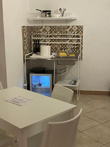 a kitchen with a table and a table and chairs at Napoli Apartment in Naples