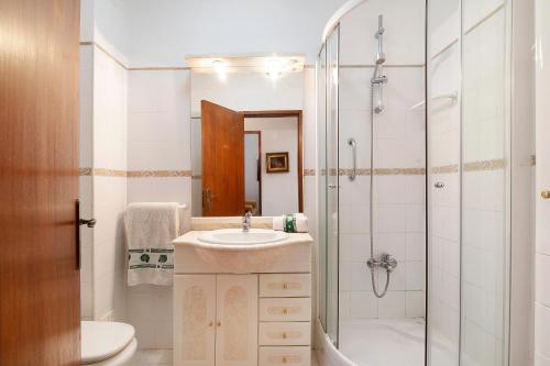 a bathroom with a sink and a shower at Apartamento Santos in Tavira