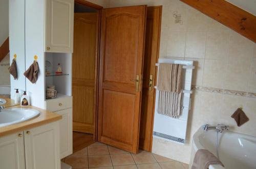 a bathroom with a sink and a bath tub at Chambre d'Hôtes Plesnois in Plesnois